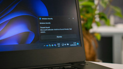 A laptop in dark mode with a Windows Security warning box