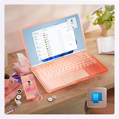 A pink book, mug, sticky notes, mobile phone and open laptop sitting on a desk.