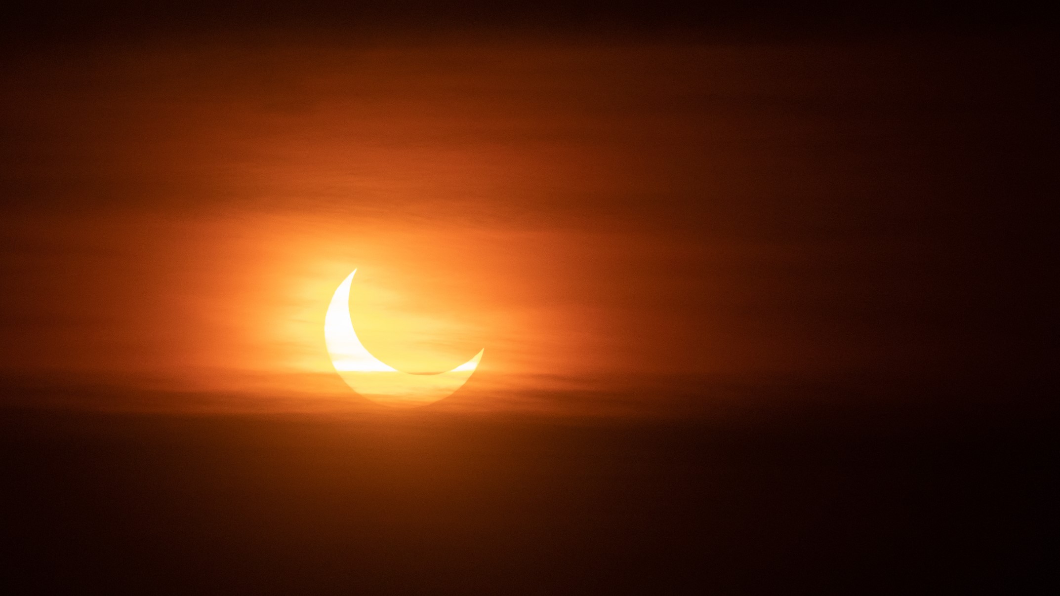 Partial solar eclipse at sunset.
