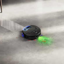 Dyson Spot+Scrub Ai robot vacuum mopping floor with kitchen chairs in peripheral view