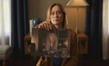 A woman holds out a photograph in "Shelby Oaks."