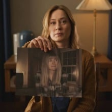 A woman holds out a photograph in "Shelby Oaks."