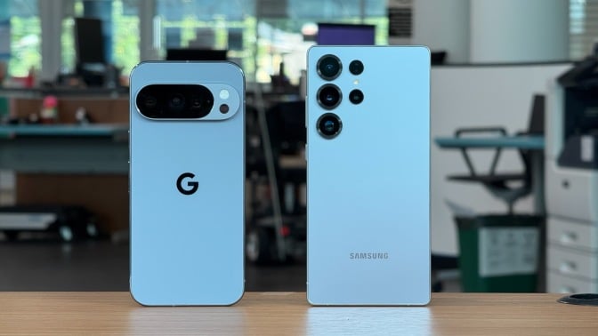 google pixel 10 pro and samsung galaxy s25 ultra standing on desk