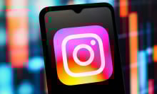 Instagram logo is seen displayed on a smartphone screen.