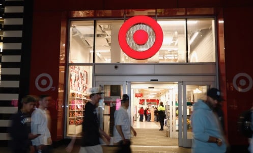people walk outside a target store at night