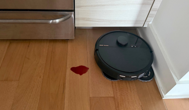 Roomba Plus 505 Combo mopping hardwood floor near wine spill and oven