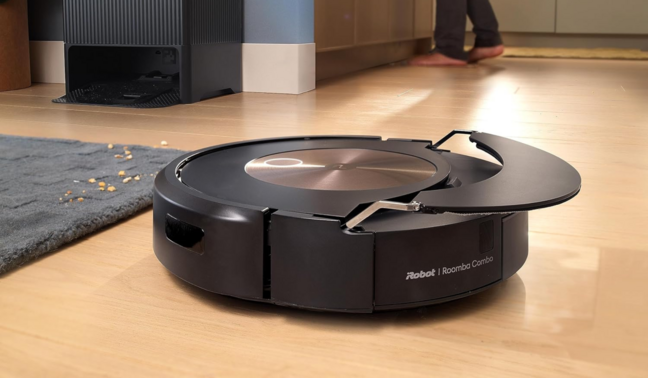 Roomba Combo j9+ mopping hardwood floor with dock and person's feet in background