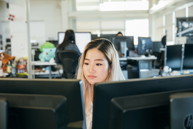 A female engineer looking at monitors.