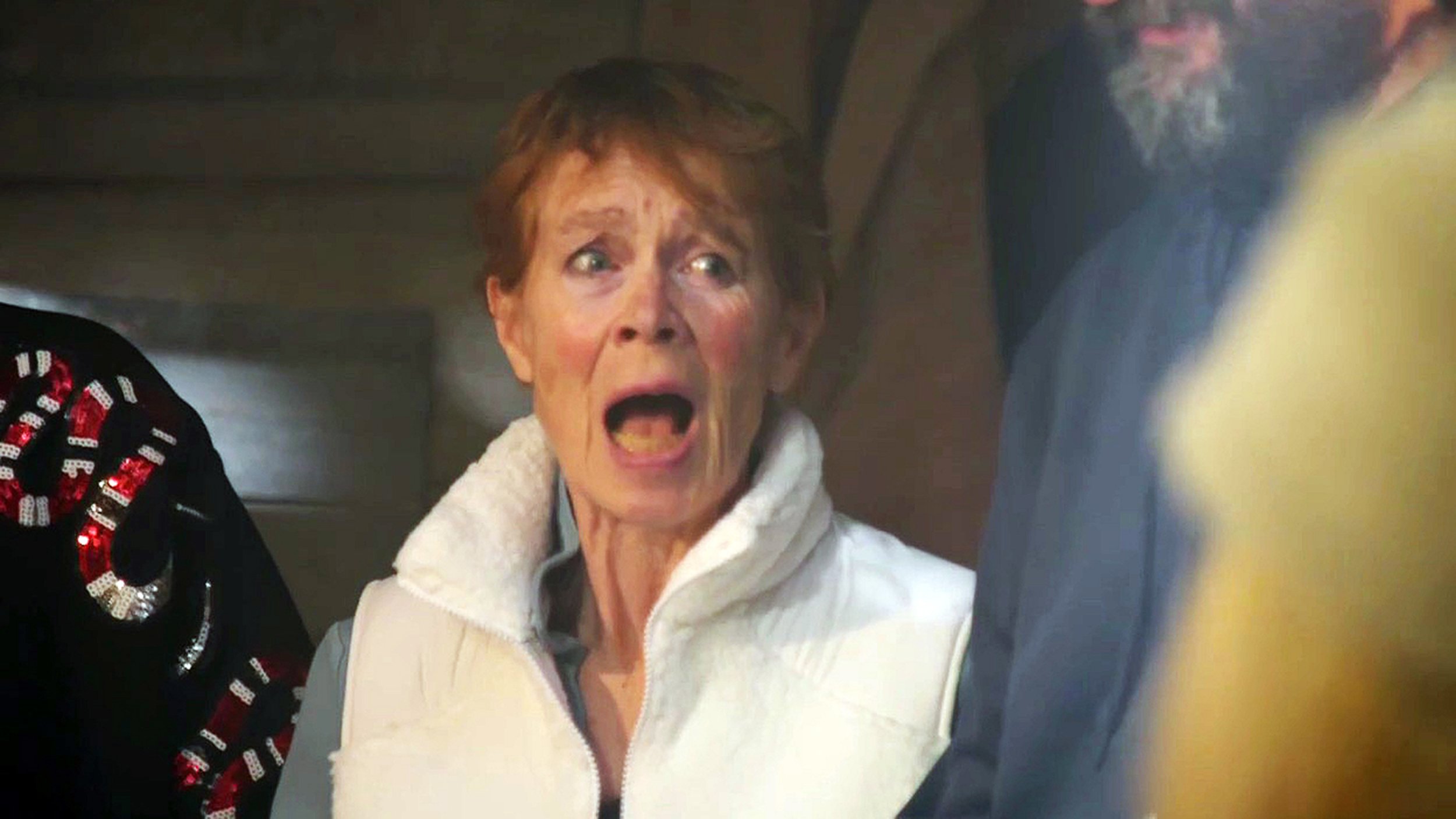 An older woman in a white gilet (Celia Imrie) looks shocked after farting in The Celebrity Traitors.