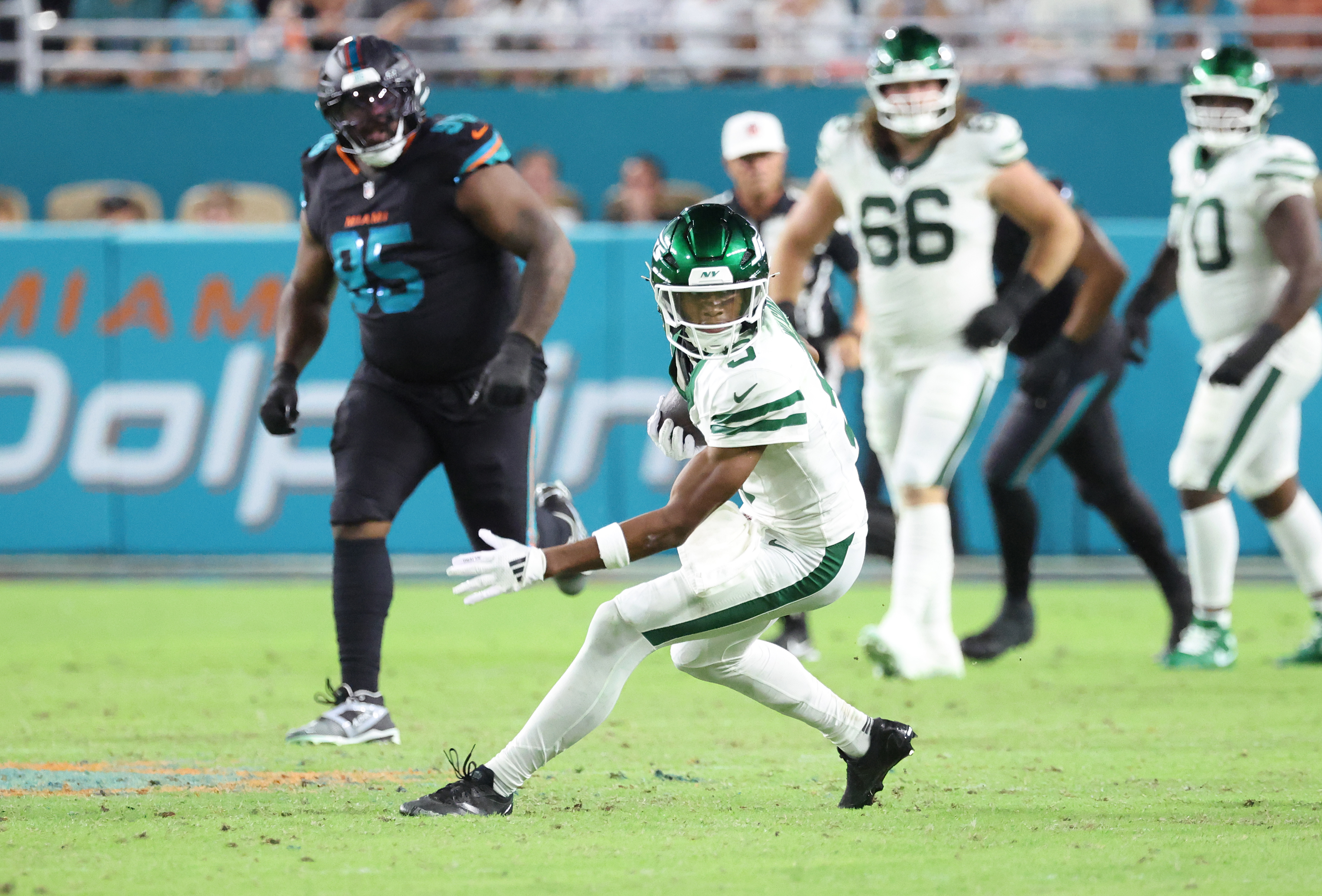 Dolphins at Hard Rock Stadium: Wide receiver Garrett Wilson #5 of the New York Jets runs the ball during the third quarter.
