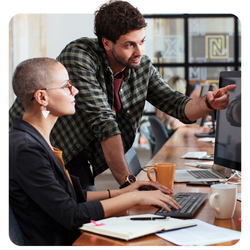 A team of colleagues gathered around a office huddle space