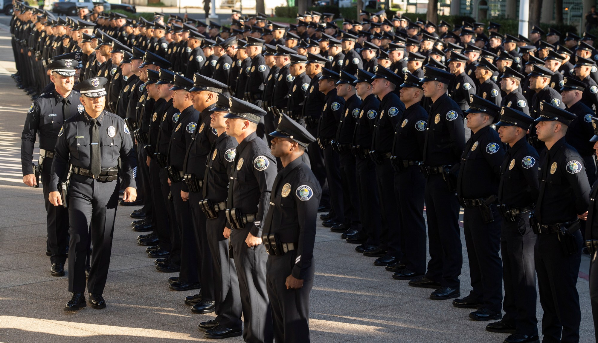 Above, in 2018 Santa Ana Chief of Police David Valentin and his deputy chiefs walk the line of officers during an inspection at their headquarters in Santa Ana, CA. (Photo by Paul Bersebach, Orange County Register/SCNG)
