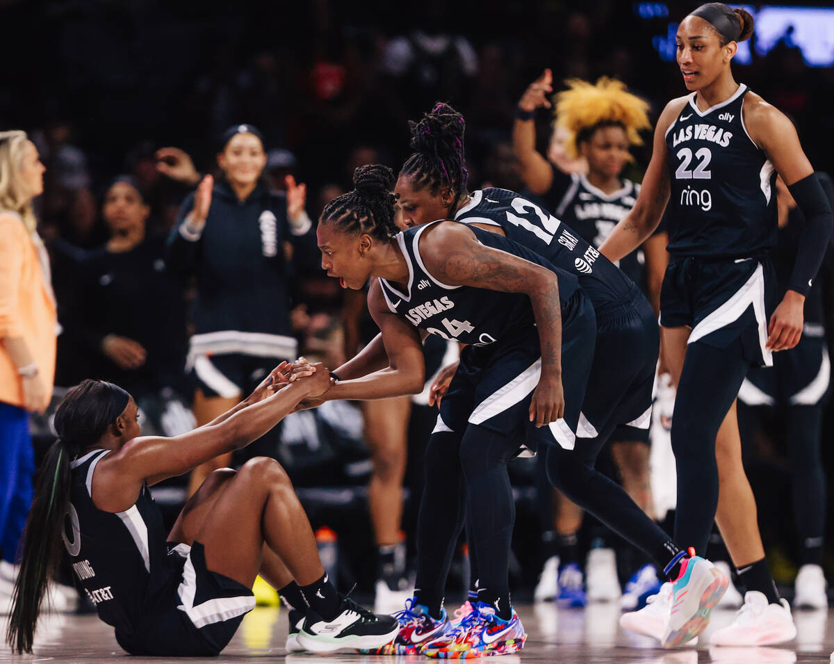 The Aces celebrate Aces guard Jackie Young drawing a foul during a WNBA basketball game between ...