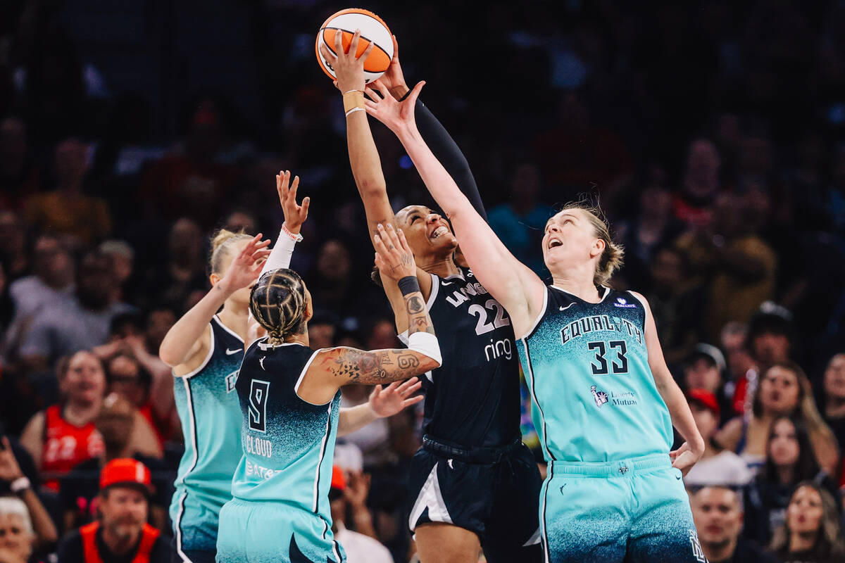Aces center A'ja Wilson (22) grabs the ball for a rebound during a WNBA basketball game be ...