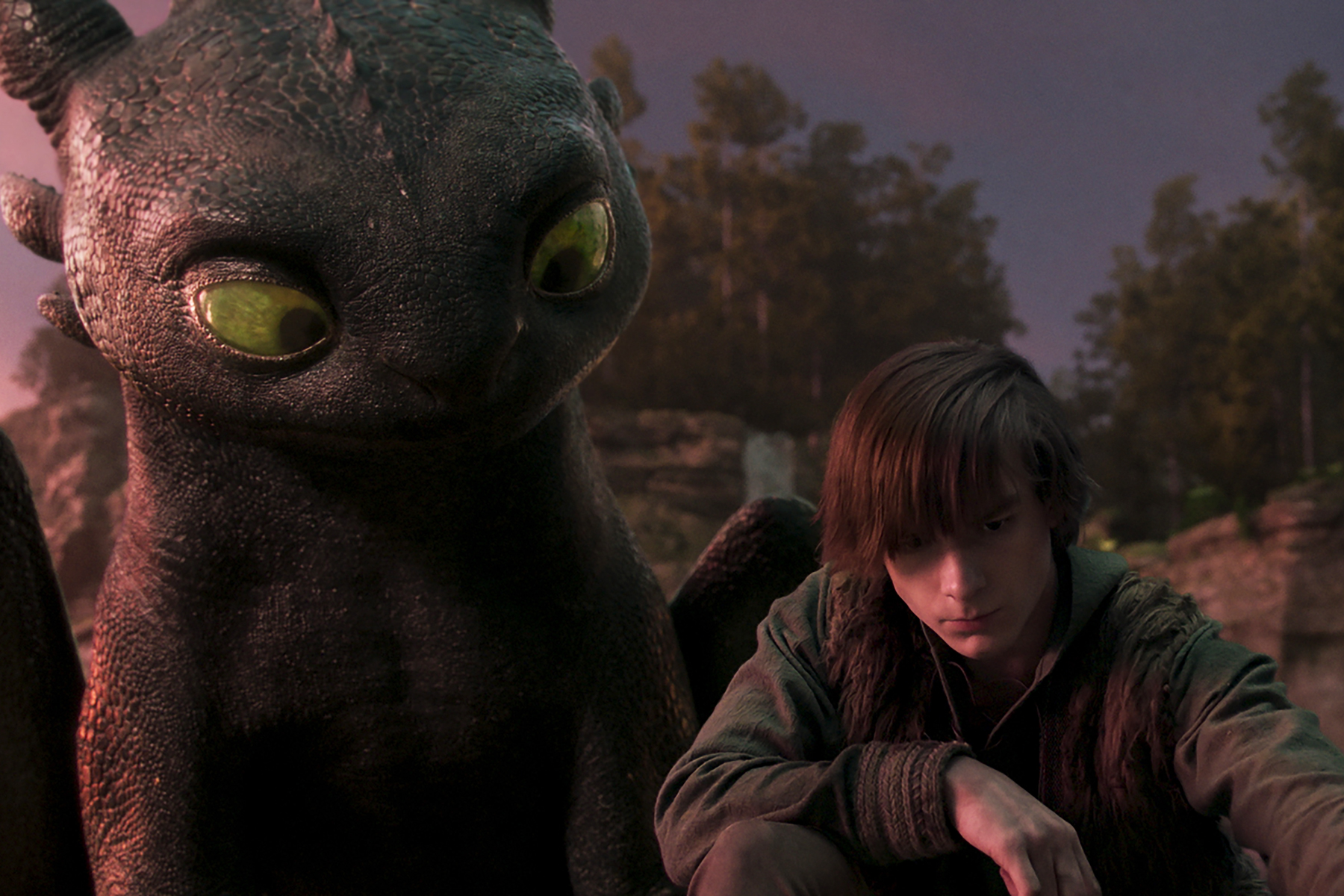 (from left) Night Fury dragon, Toothless, and Hiccup (Mason Thames) in Universal Pictures’ live-action How to Train Your Dragon, written and directed by Dean DeBlois.
